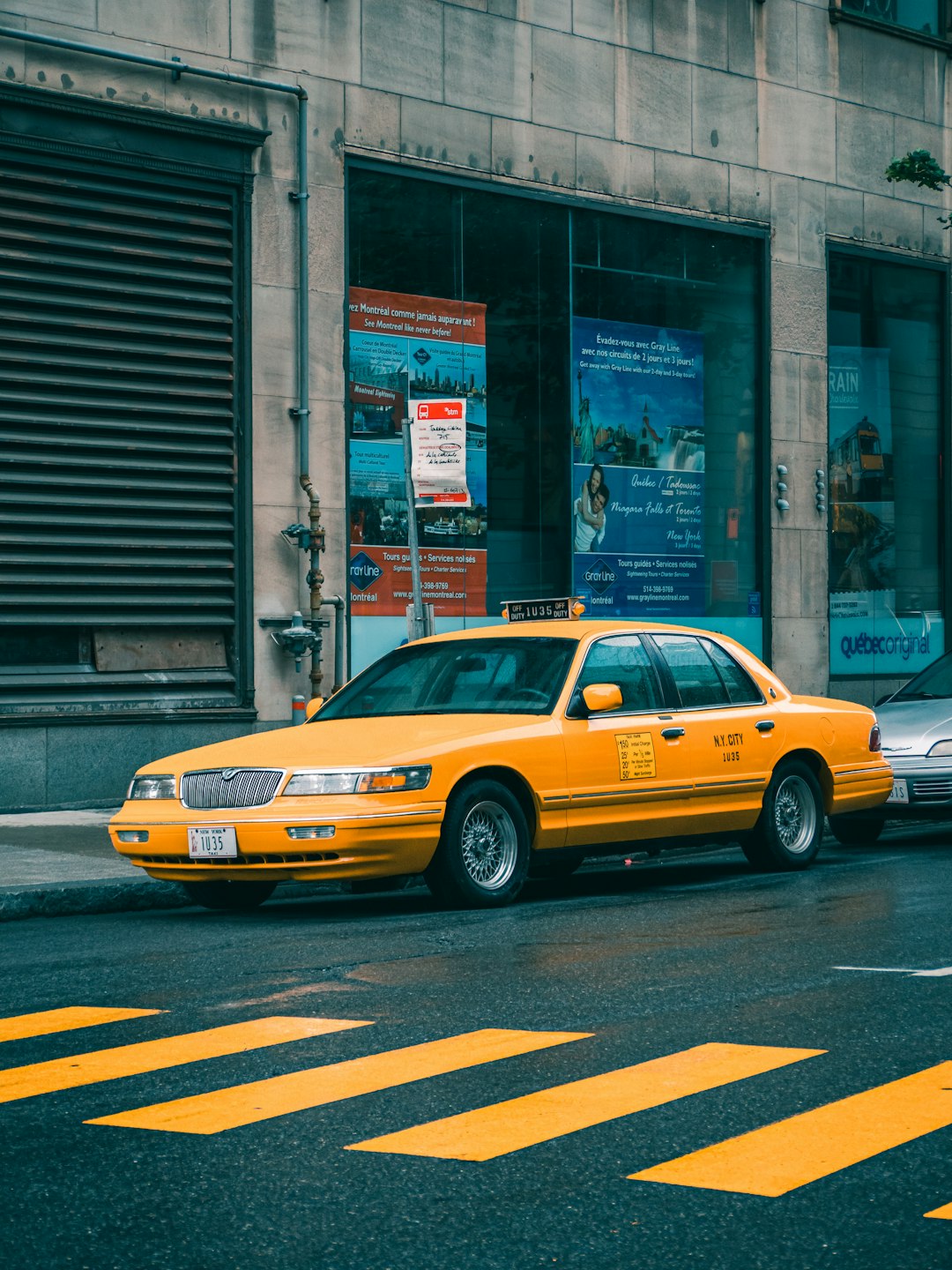 yellow-taxi-cab-on-street-during-daytime-lopl80hjsps